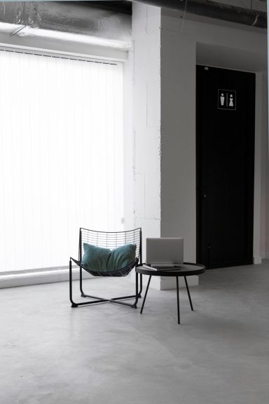 Modernes Interieur Modernes Interieur mit einem Stuhl, einem Tisch und einem Laptop vor einem Fenster.